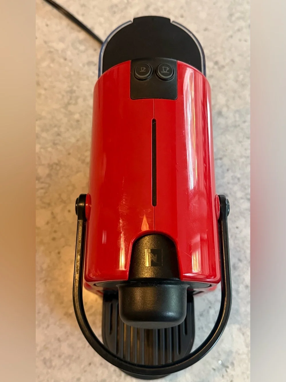 Nespresso Red Single-Serve Espresso Machine with Black Accents.